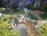 A scenic hiking trail winding through dense jungle with glimpses of distant ocean views.
