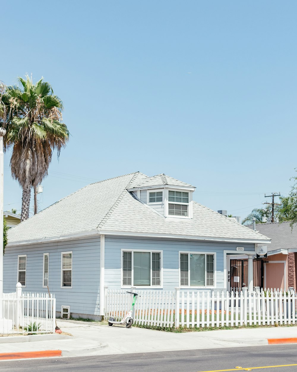 a blue house with a white picket fence