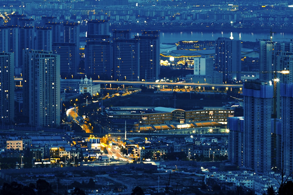 a view of a city at night from the top of a hill