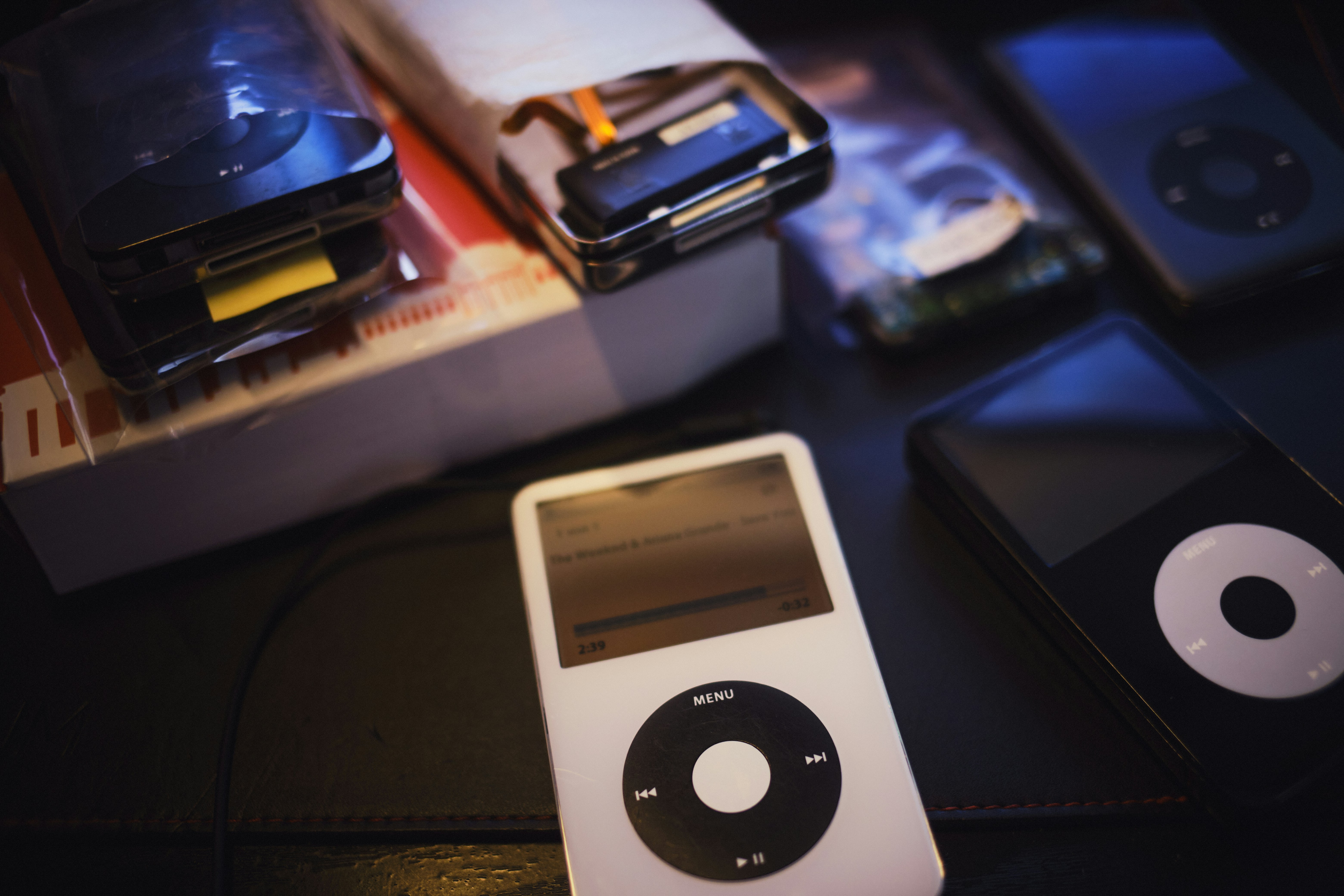 an ipod sitting on top of a table next to other electronics