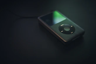 A minimalist dark mode music player interface glowing softly against a charcoal background.