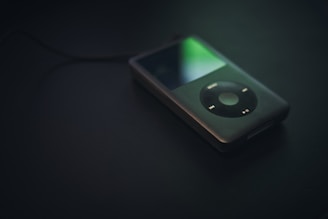 A close-up of a vintage Minidisc player with a glowing display.