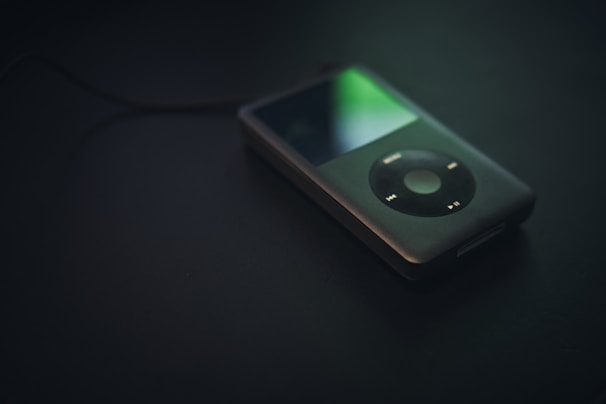 Several iPods and portable music players arranged to emphasize their compactness and style.