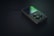A classic portable music player is lying on a dark surface, with a circular control pad and a small screen. The lighting is dim, emphasizing the sleek and minimalist design of the device.