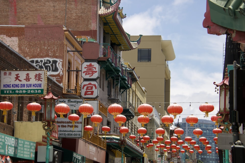 a city street filled with lots of red lanterns