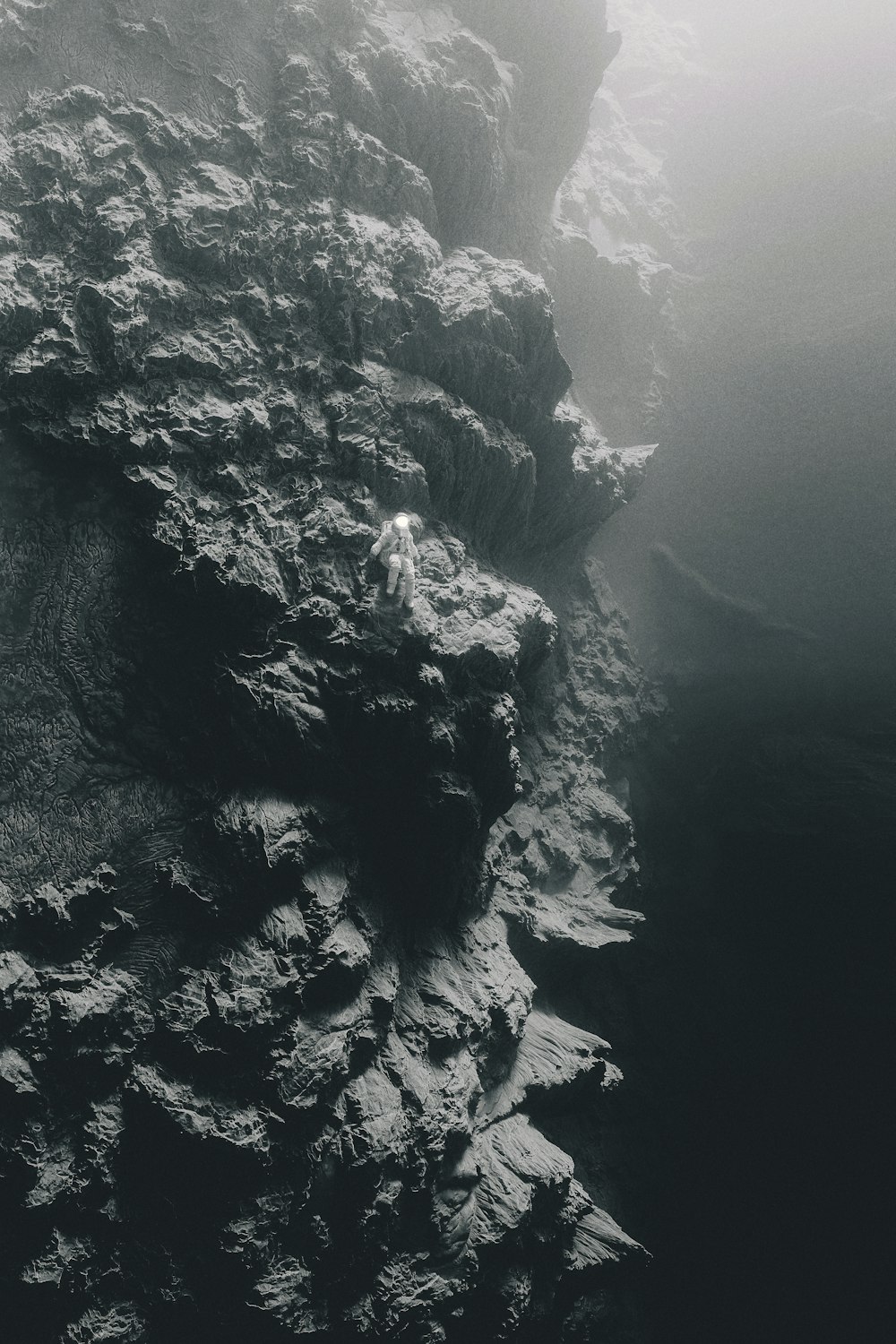 a black and white photo of a rock formation