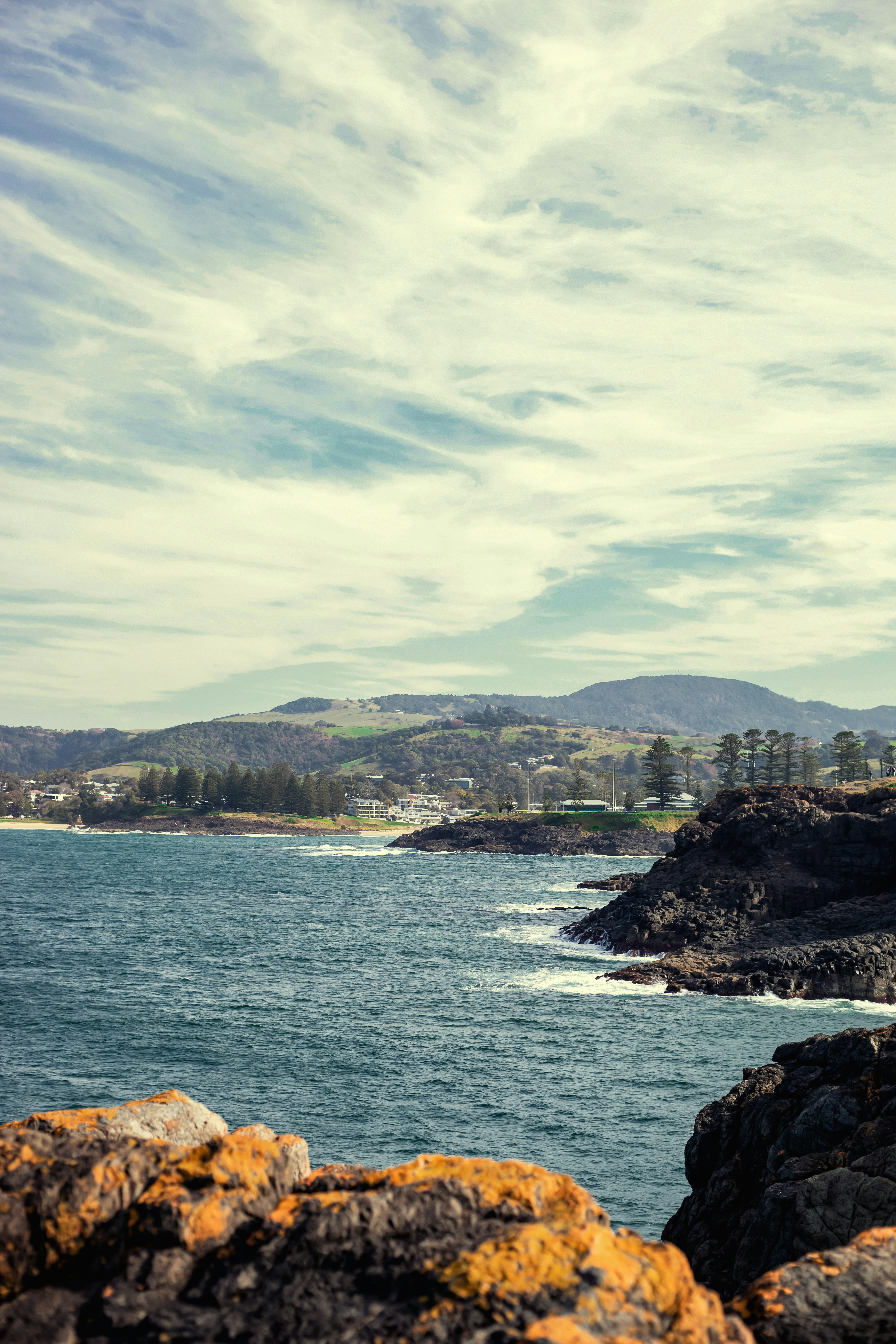 A lighthouse on a rocky shore near the ocean photo – Free Australia ...
