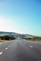 A scenic highway with diverse vehicles driving smoothly, symbolizing the freedom of the open road.