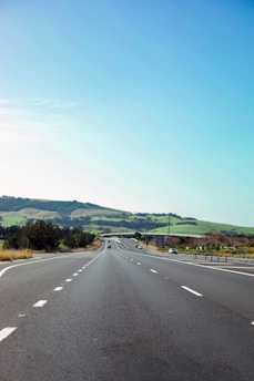 A scenic highway with diverse vehicles driving smoothly, symbolizing the freedom of the open road.