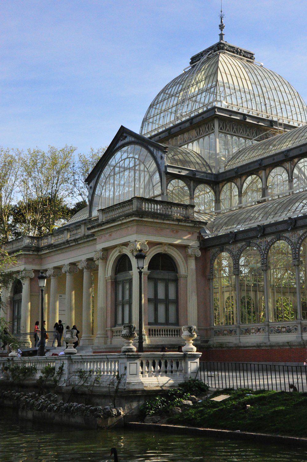 a building with a glass roof next to a body of water