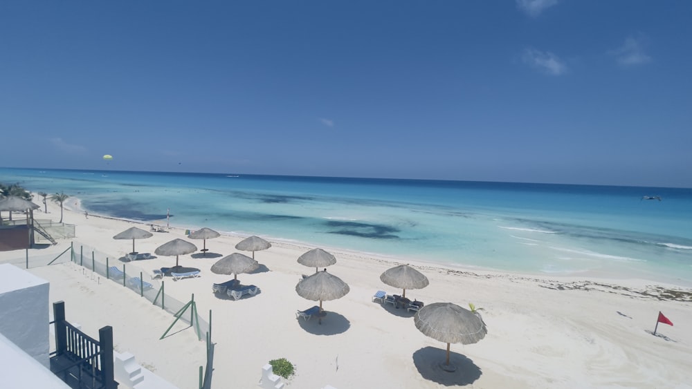 a beach with umbrellas and chairs on it