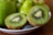 Close-up of ripe kiwis and stone fruits arranged beautifully.
