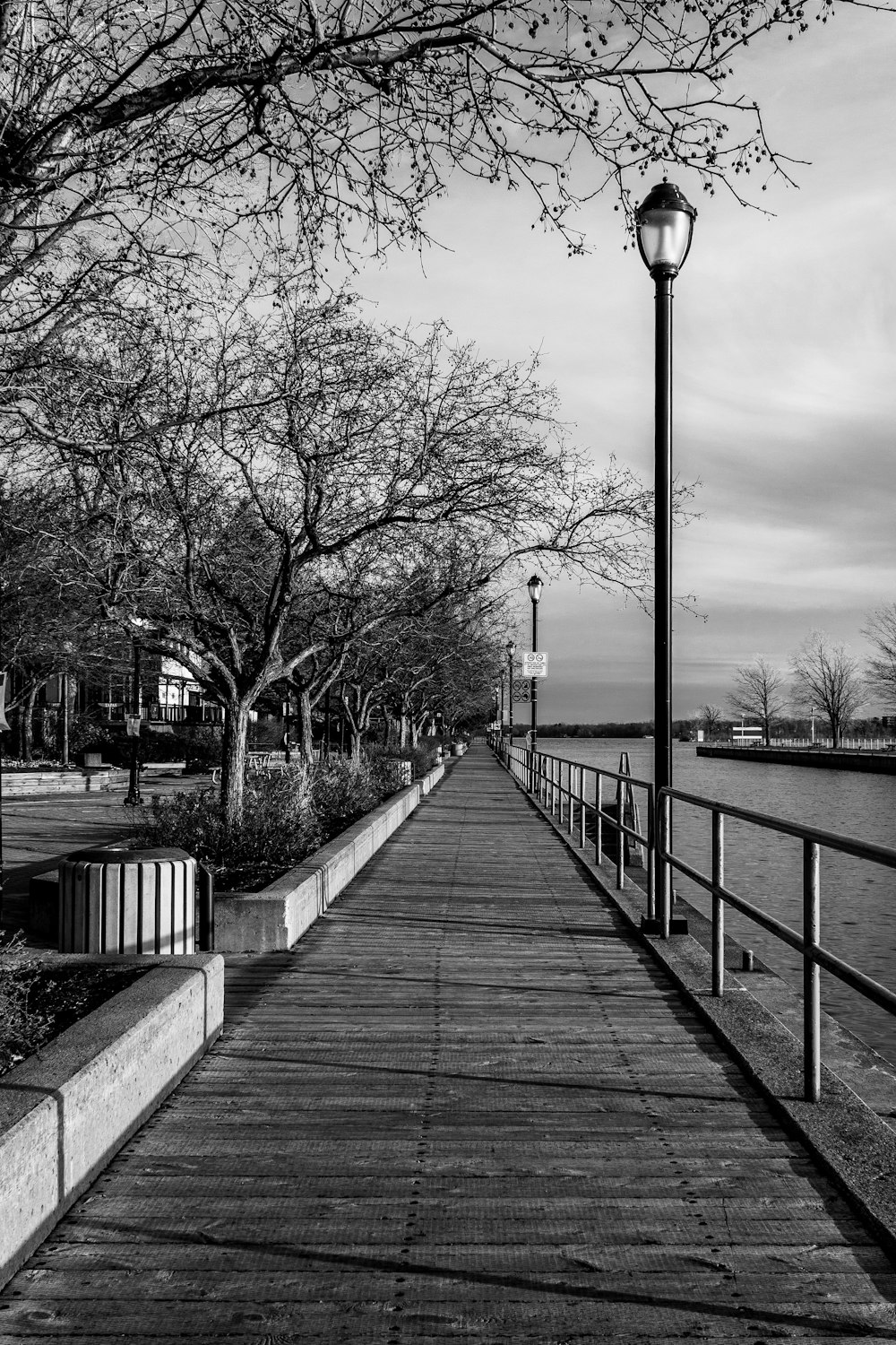 a black and white photo of a long pier