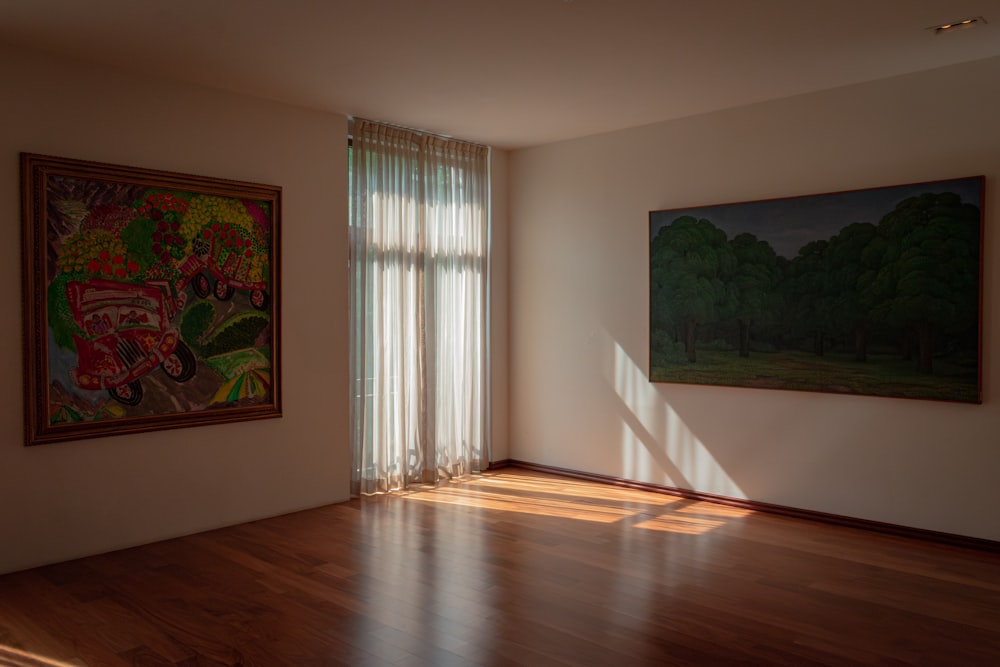 an empty room with a painting on the wall