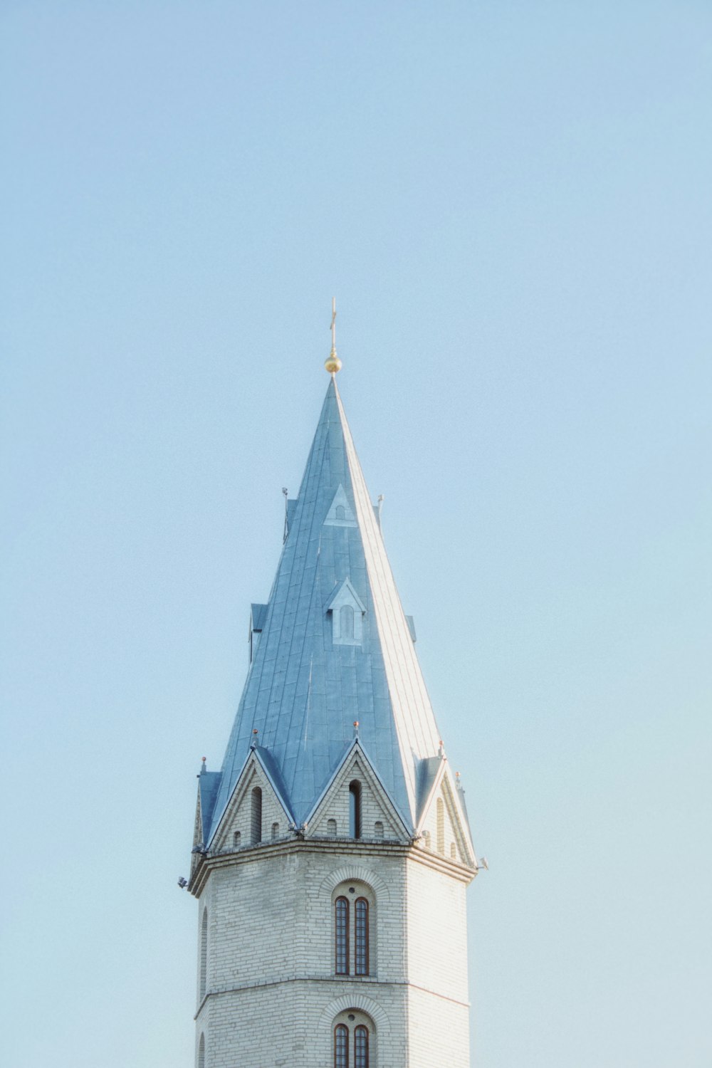 a tall tower with a clock on the top of it