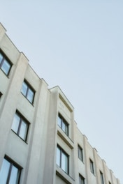 a tall white building with lots of windows