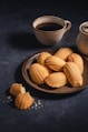 a plate of cookies next to a cup of coffee