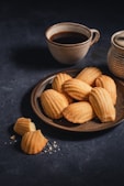 a plate of cookies next to a cup of coffee