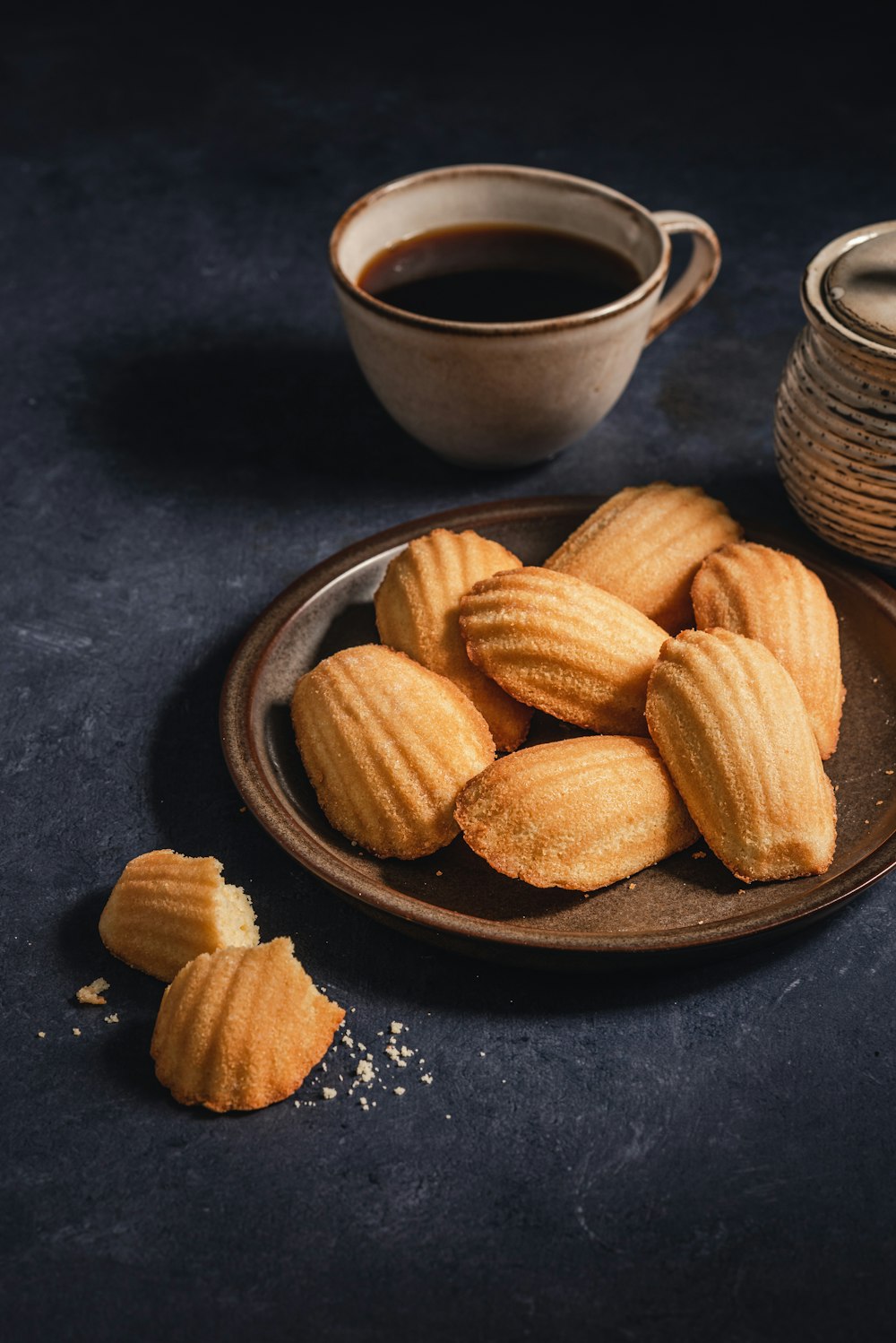 a plate of cookies next to a cup of coffee