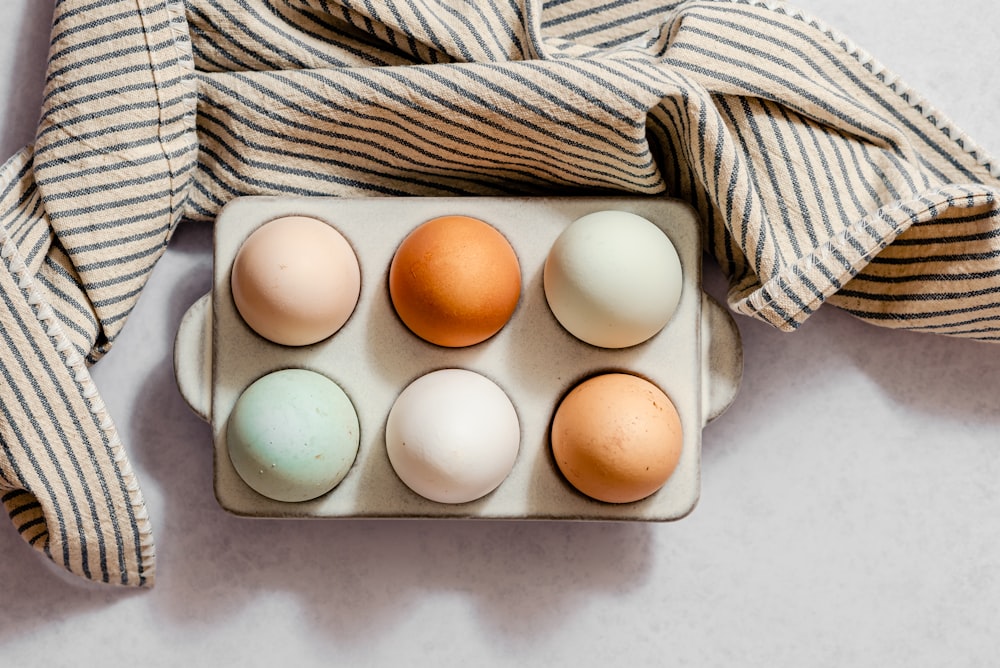 a dozen of eggs in a carton on a table