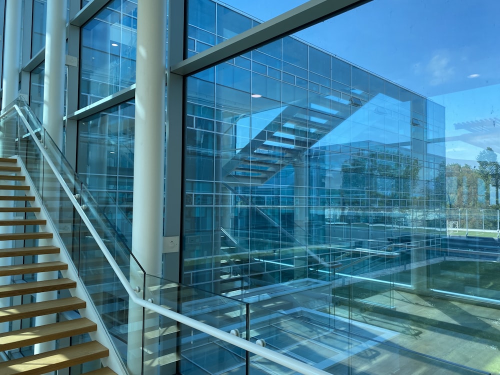 a large glass building with a staircase leading up to it