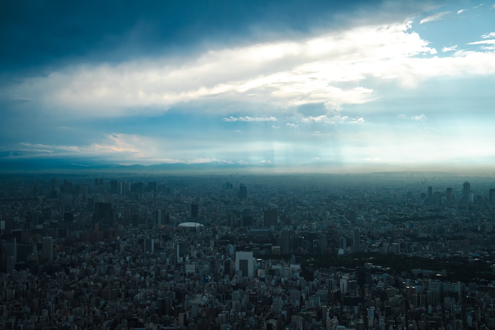 an aerial view of a city under a cloudy sky