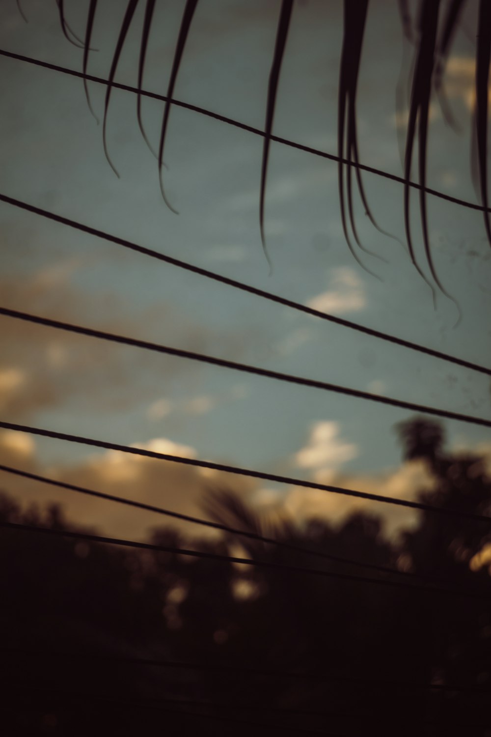 a blurry photo of a telephone pole with a sky in the background