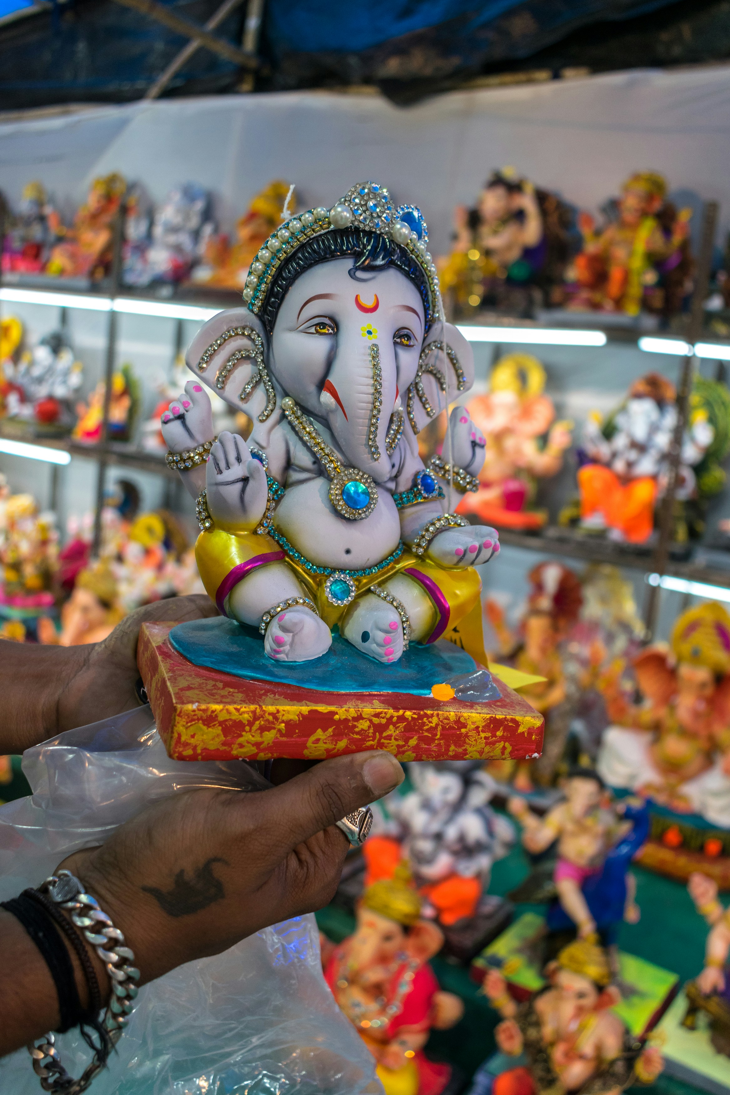 a person holding a small statue of an elephant