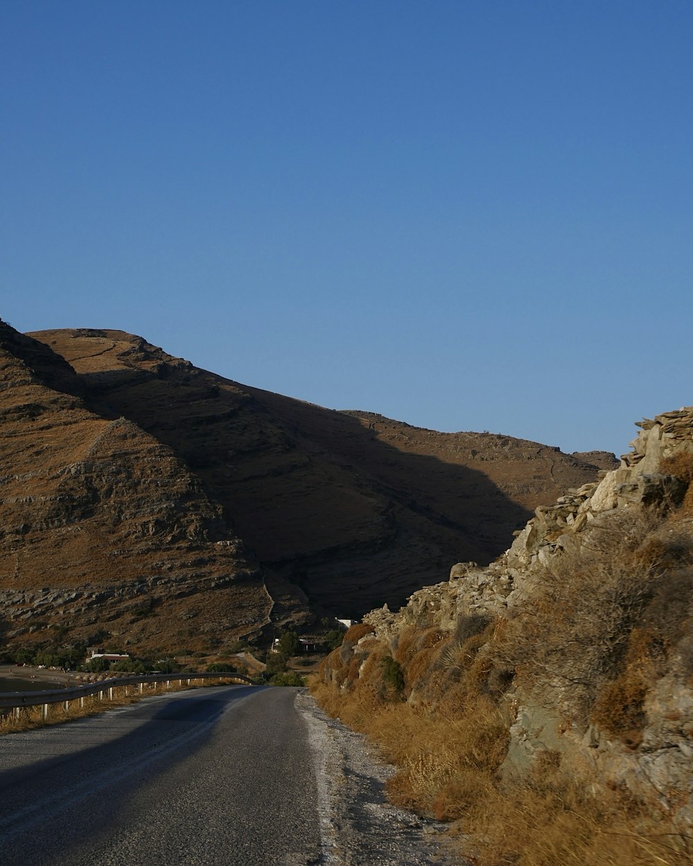 a road with a mountain in the background