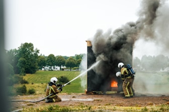 a couple of fire fighters are putting out a fire