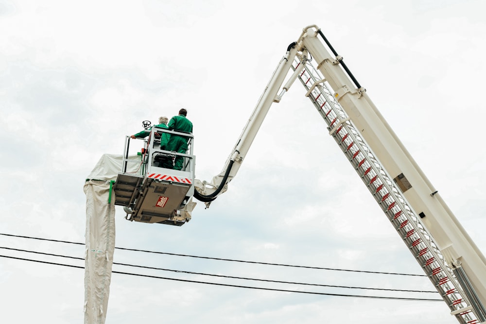 a man on a cherry picker working on power lines