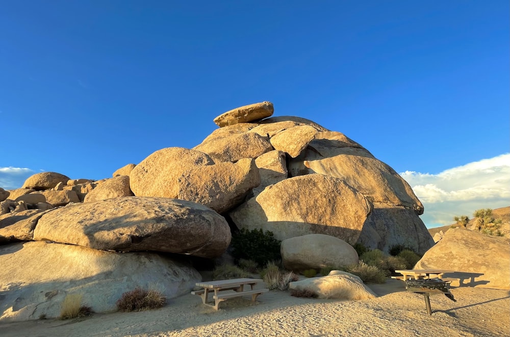 a bench sitting on top of a pile of rocks