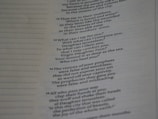 A close-up of a page from a book, featuring text in a poetic or biblical format with numbered sections. The text is focused on themes of comparison, comfort, and false visions. The left margin of the page includes evenly spaced dotted lines.