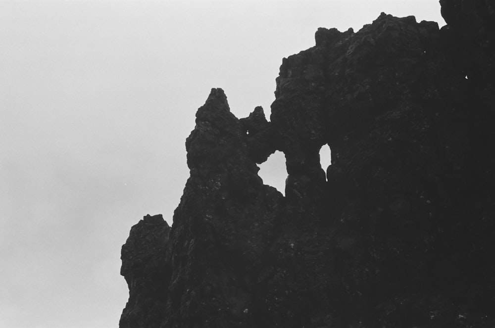 a black and white photo of a rock formation