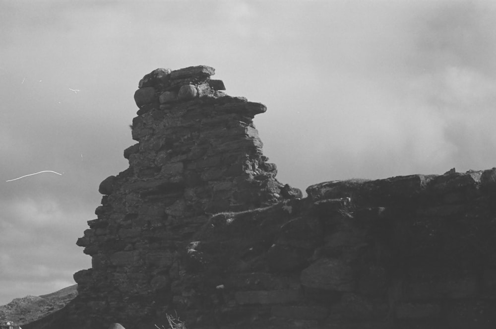 a black and white photo of a stone tower