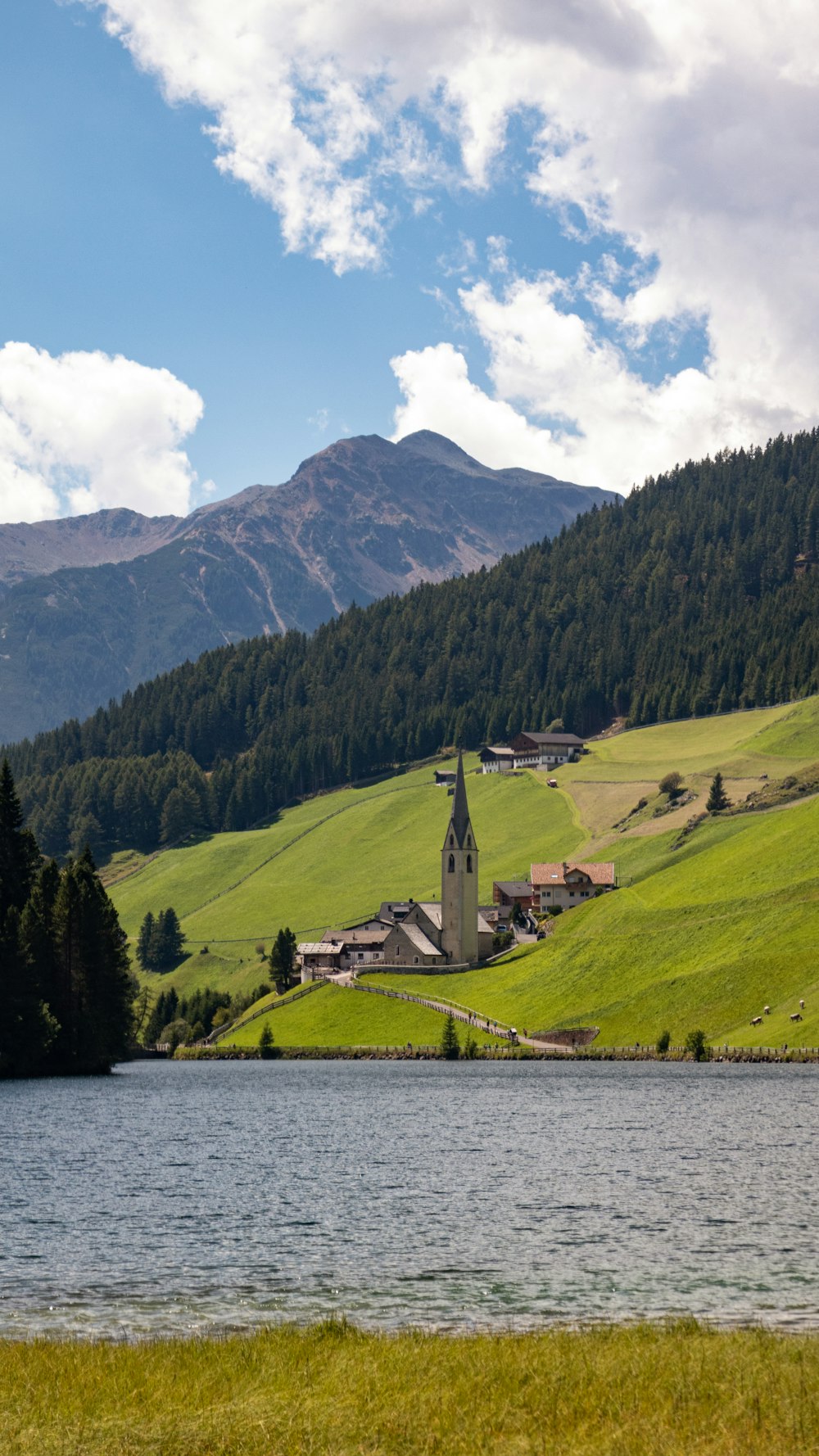 a church in the middle of a green valley