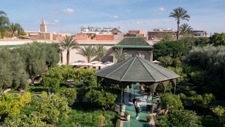 a gazebo in the middle of a lush green park