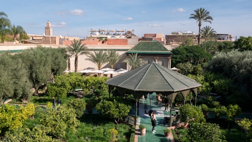 a gazebo in the middle of a lush green park