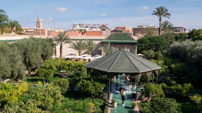 a gazebo in the middle of a lush green park