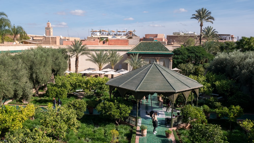 a gazebo in the middle of a lush green park