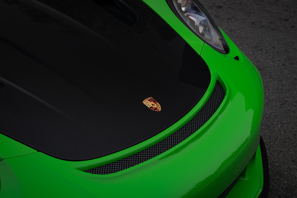 a close up of the hood of a green sports car