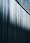 a close up of a metal fence with a sky background
