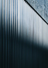 a close up of a metal fence with a sky background