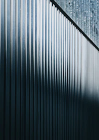 a close up of a metal fence with a sky background