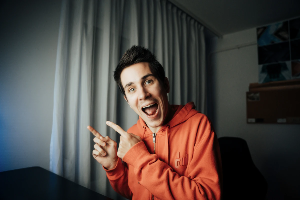 Smiling man in an orange loopback hoodie