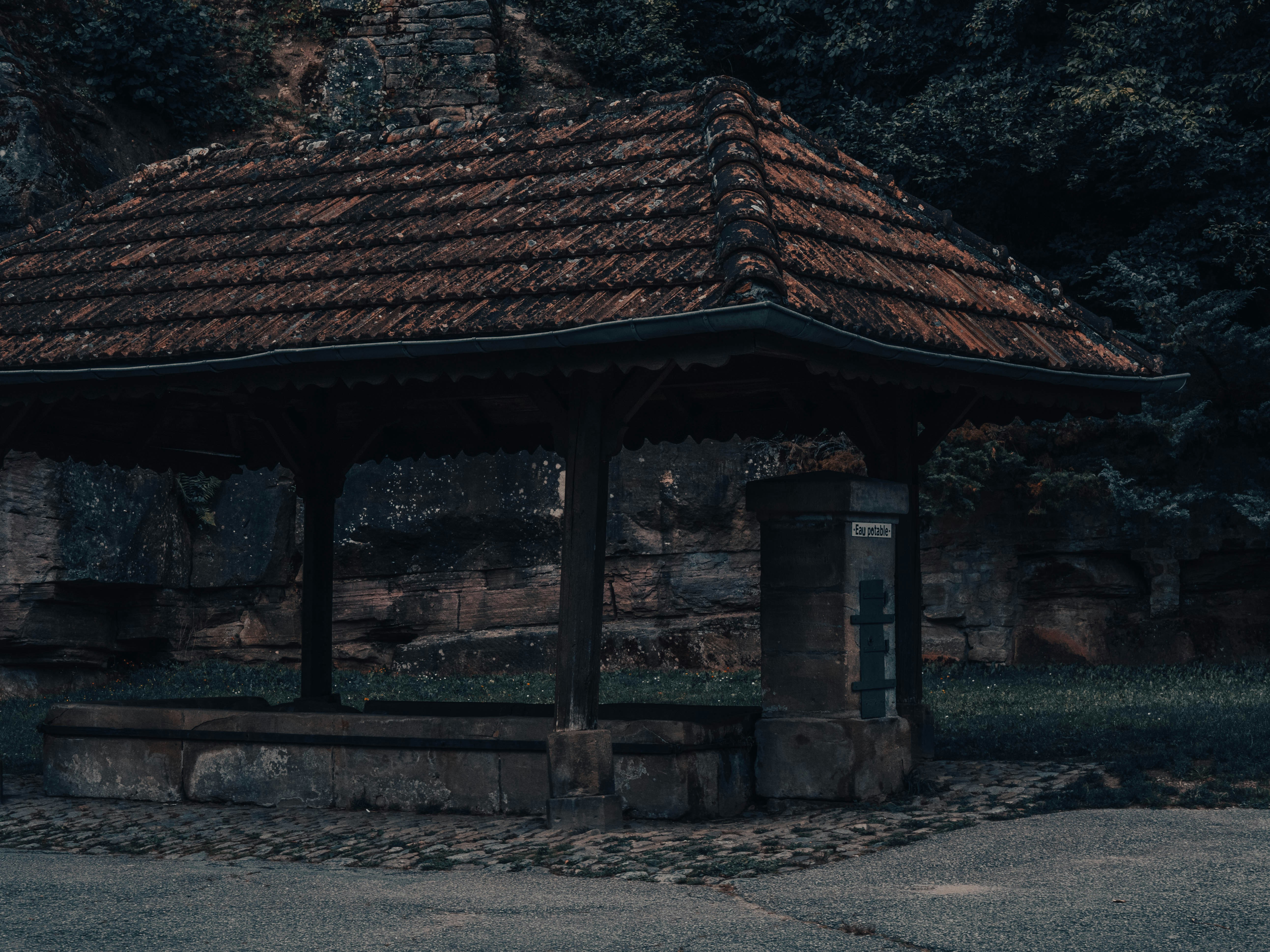 a gazebo in the middle of a park with trees in the background