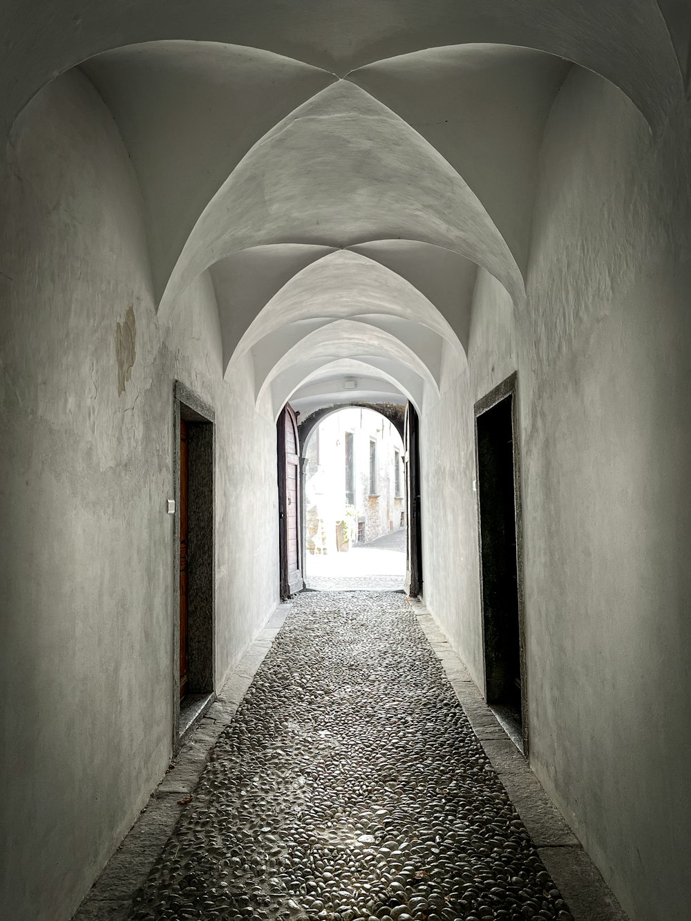 a long narrow hallway with a stone floor