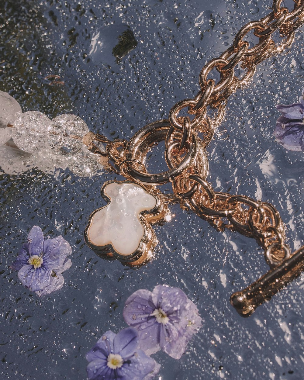 a close up of a chain with flowers on it