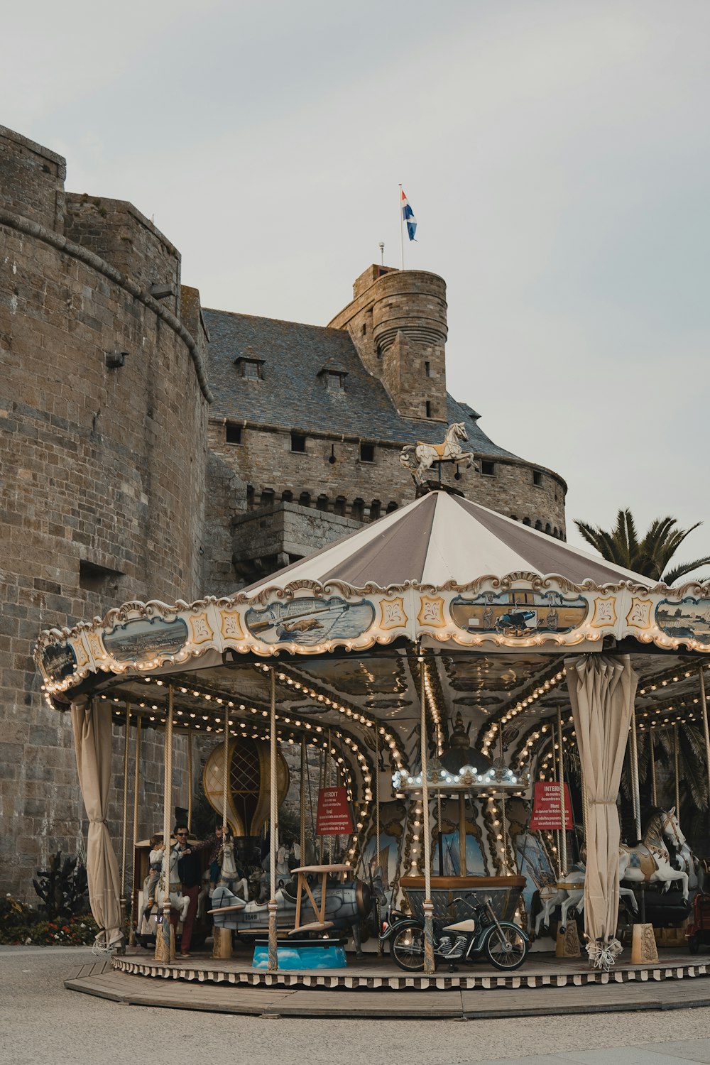 a merry go round in front of a castle