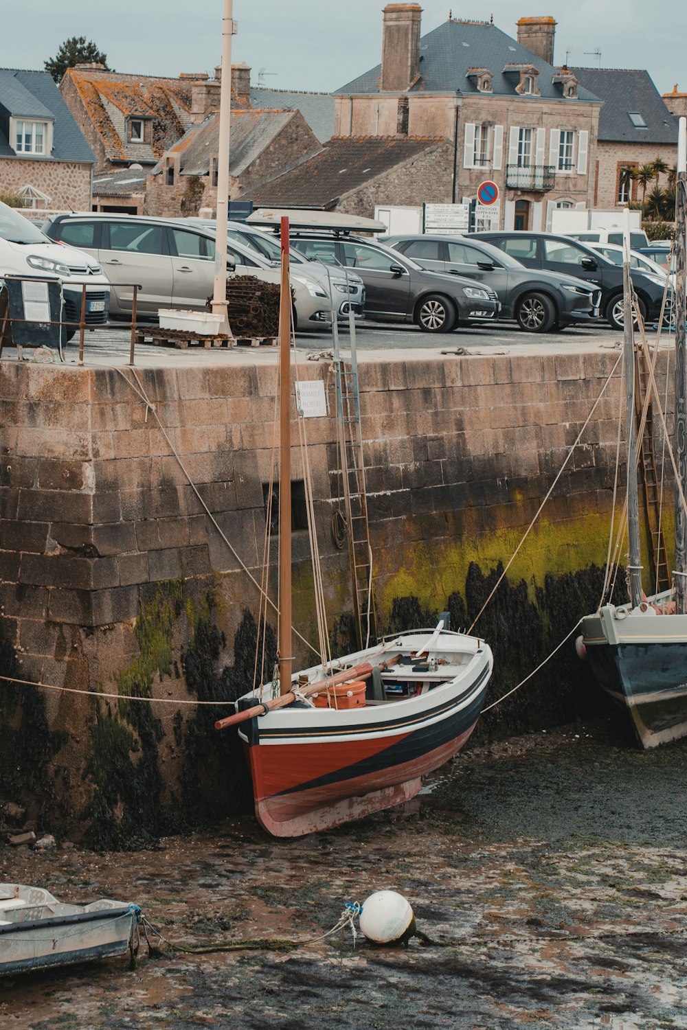 a boat tied up to a wall next to a marina